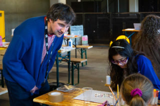 Kids Make Glasgow - Rob Johnston a photo of animator rob johnson talking to kids about their illustrations